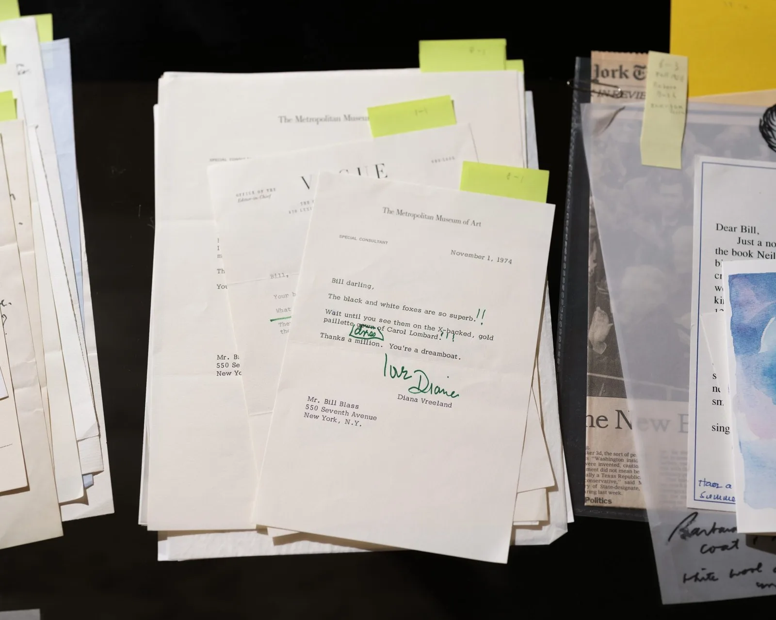 A photograph depicting stacks of letters against a black background