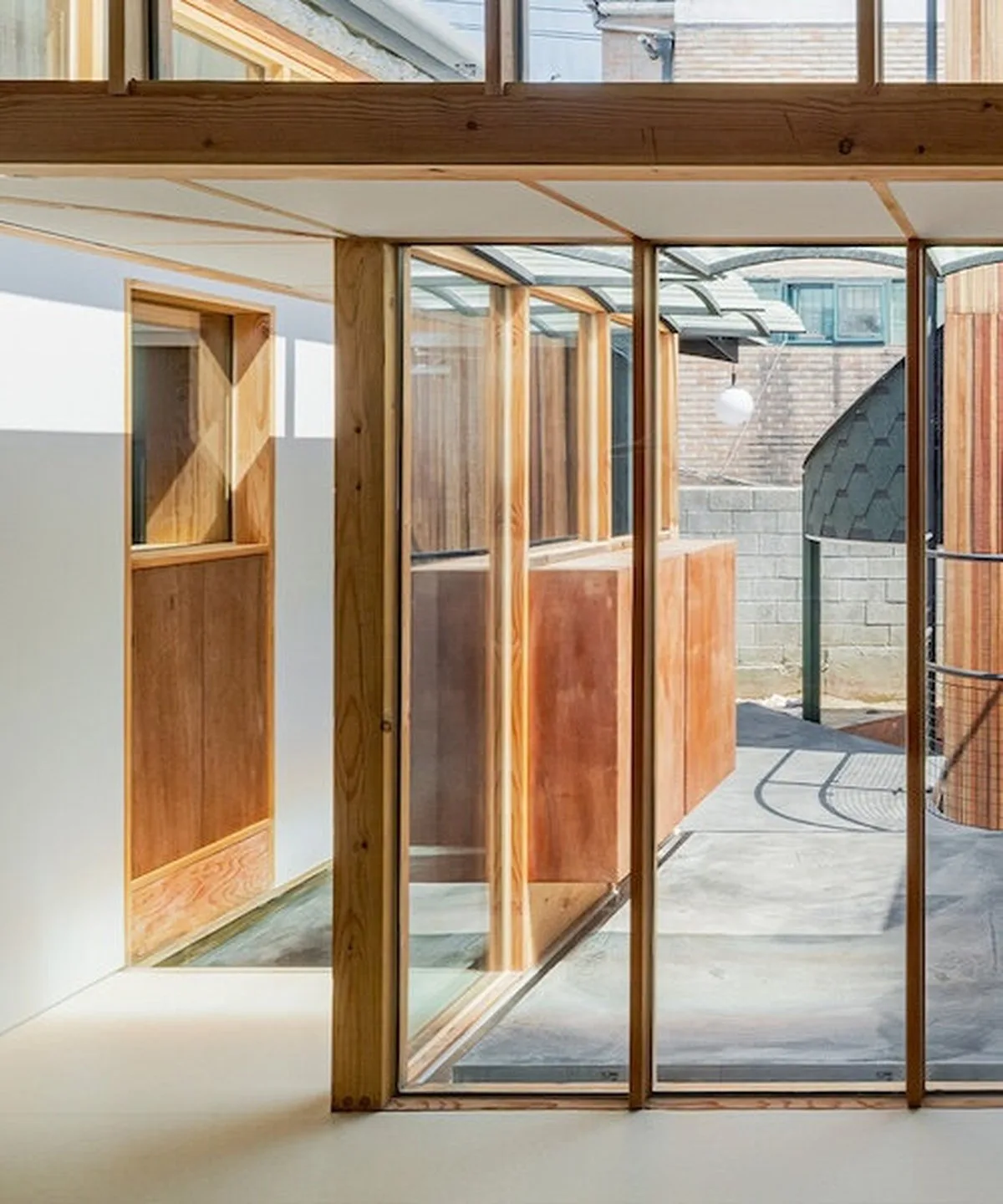 1968 seoul residence is reshaped with courtyard, annex and timber frame