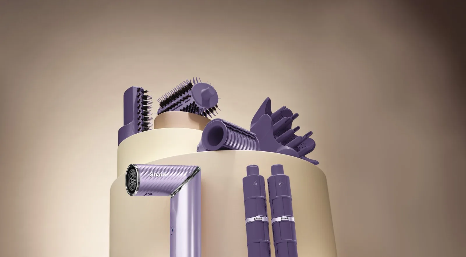 A set of purple Shark FlexStyle hair styling tools and attachments, including a hair dryer, brushes, and IonCurl curling barrels, arranged on a beige circular display against a brown background.