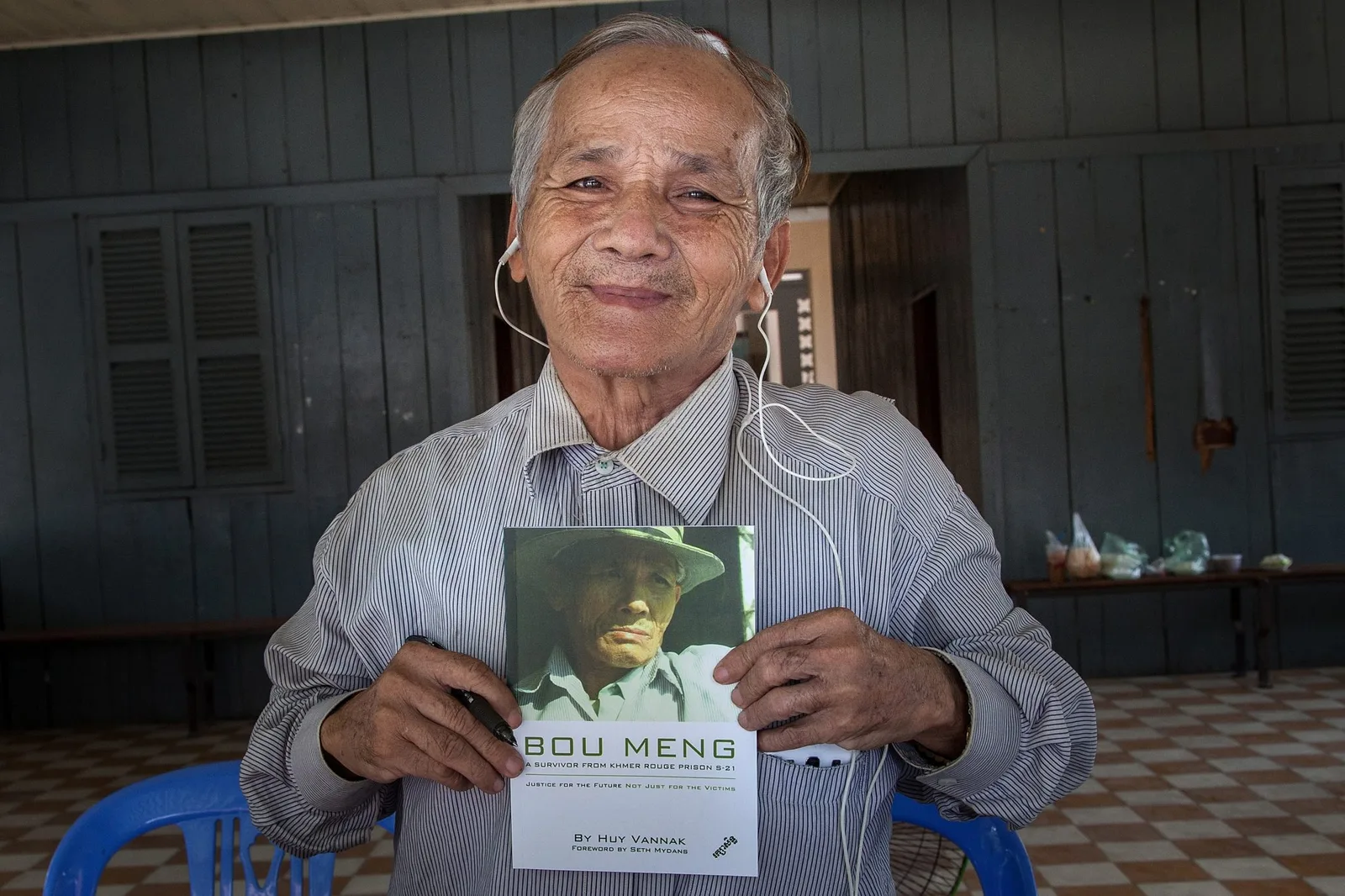 A man holds a book with his face on it