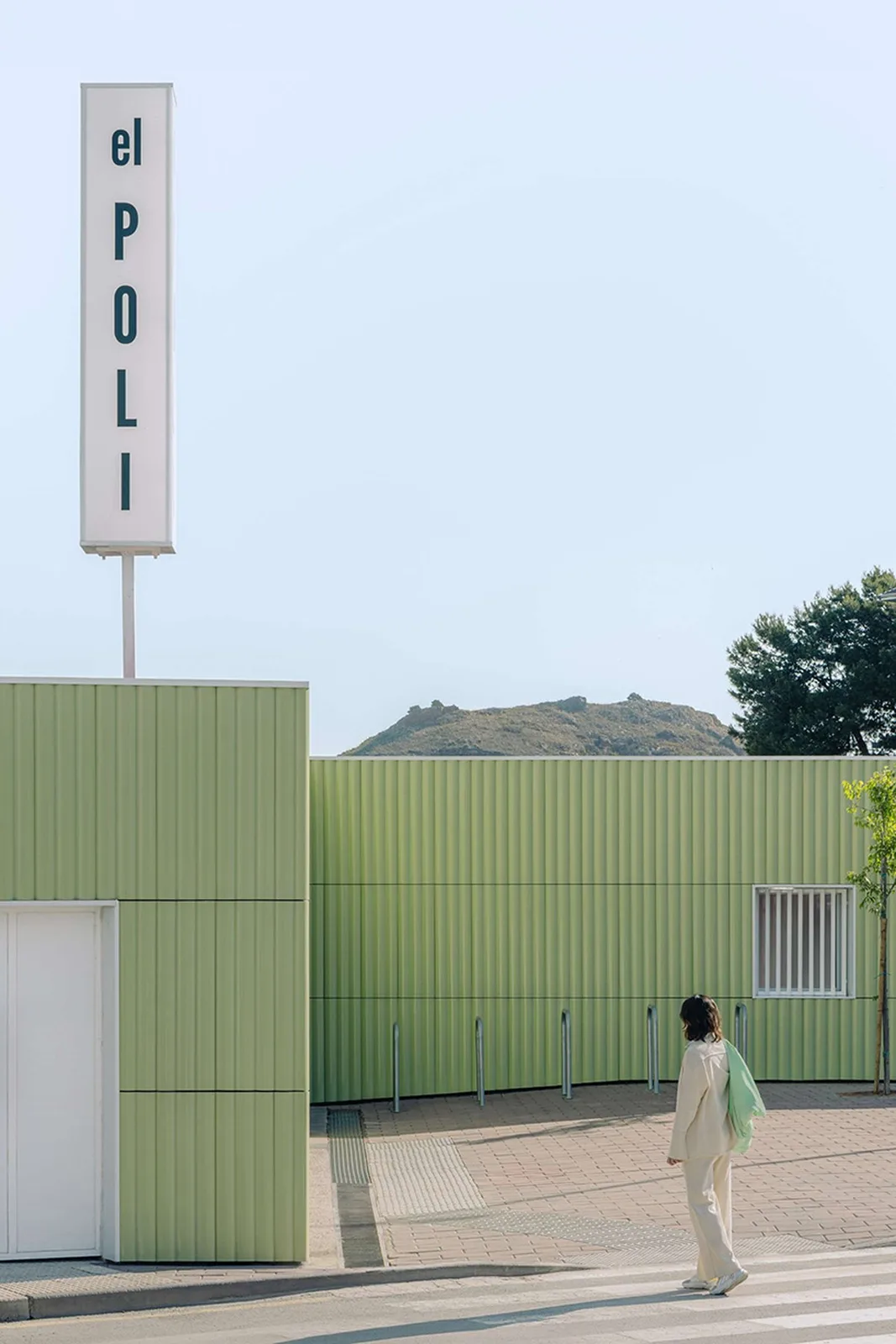 ribbed lime-green gateway and blue solar canopy reform municipal sports center in spain - 2