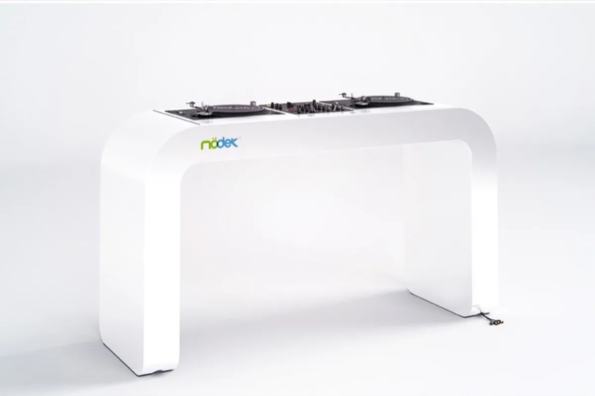 continuous white DJ console integrates turntables, mixers, and hidden cables - 3