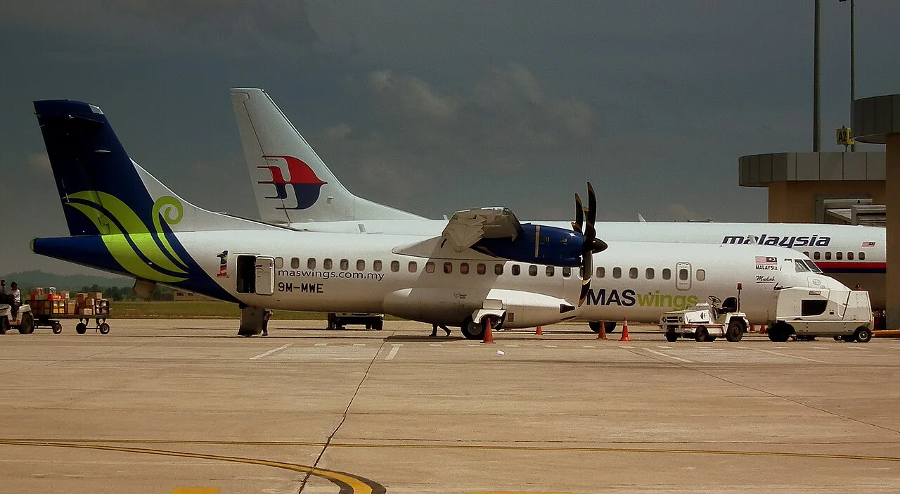 A MASwings ATR 72 parked next to a Malaysia Airlines Boeing 737